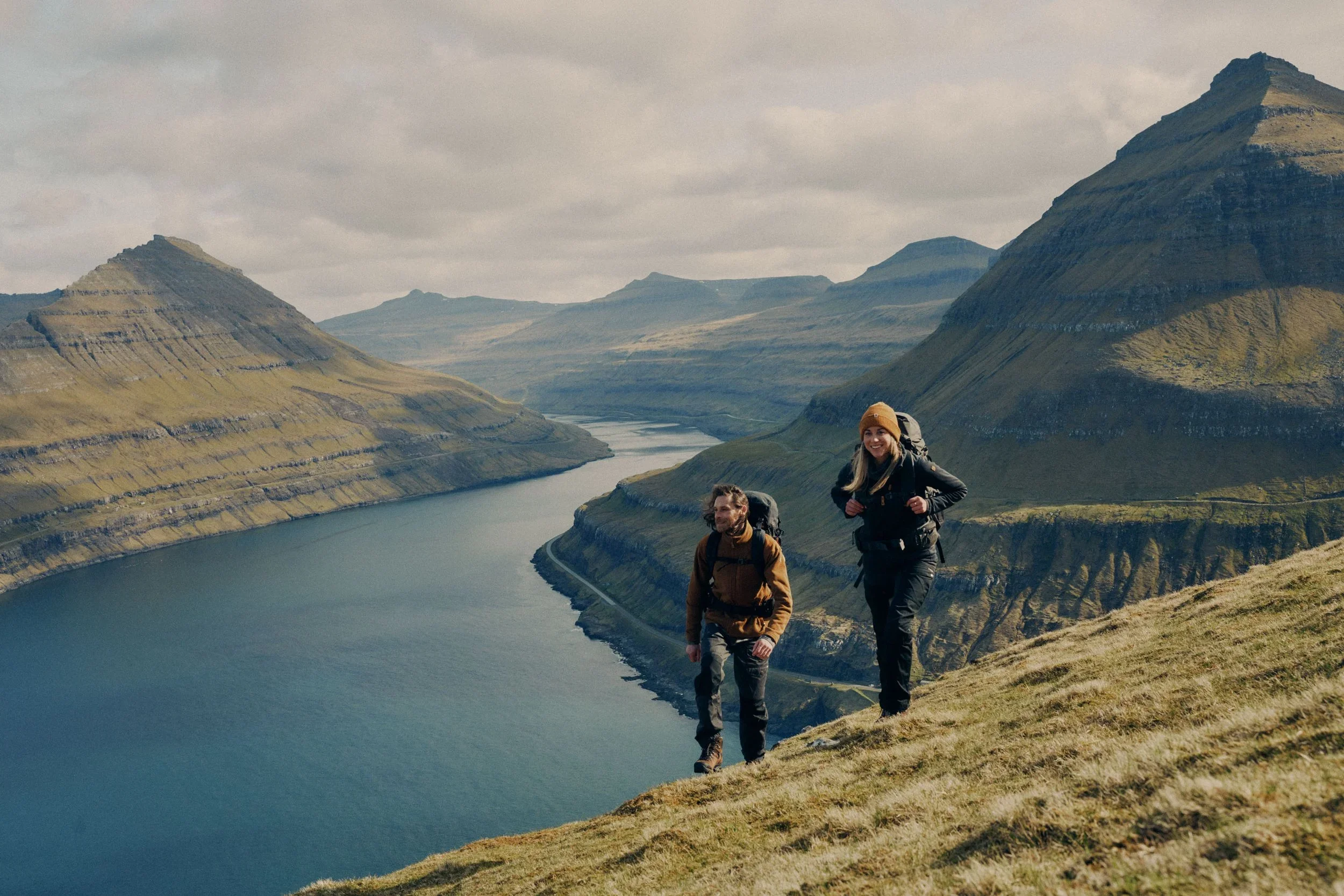 Hikers above a fjord in the Faroe Islands, photographed for Fjällräven by VAST